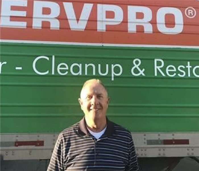 a guy in front of a SERVPRO van 