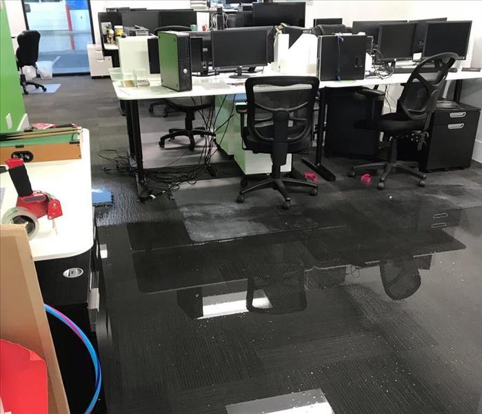 Standing water in an open office space.